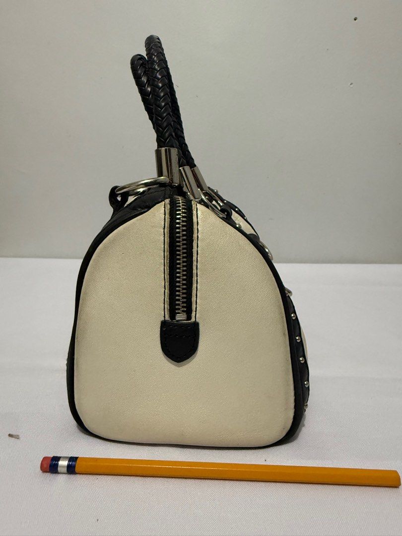 Anne Klein Handbag with Braided Handles (Category: Luxury Bags & Wallets) located in Davao. Submitted by rebaggedph (Listing ID 1402405834, Image 3). Description: Anne Klein handbag features a cream and black color scheme with a quilted pattern. It has braided handles and silver-tone hardware. The bag includes a zipper closure and a tassel detail. The Anne Klein logo is visible on the front and inside the bag. The bag has a rectangular shape with