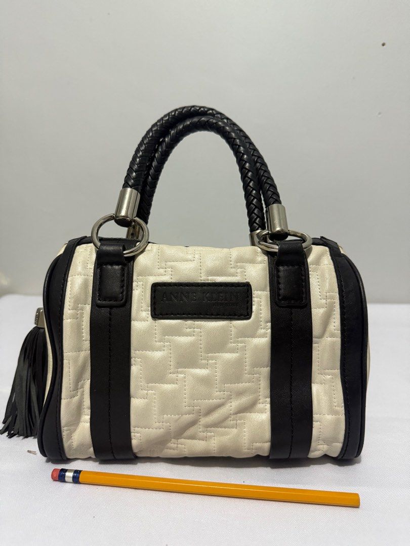 Anne Klein Handbag with Braided Handles (Category: Luxury Bags & Wallets) located in Davao. Submitted by rebaggedph (Listing ID 1402405834, Image 2). Description: Anne Klein handbag features a cream and black color scheme with a quilted pattern. It has braided handles and silver-tone hardware. The bag includes a zipper closure and a tassel detail. The Anne Klein logo is visible on the front and inside the bag. The bag has a rectangular shape with