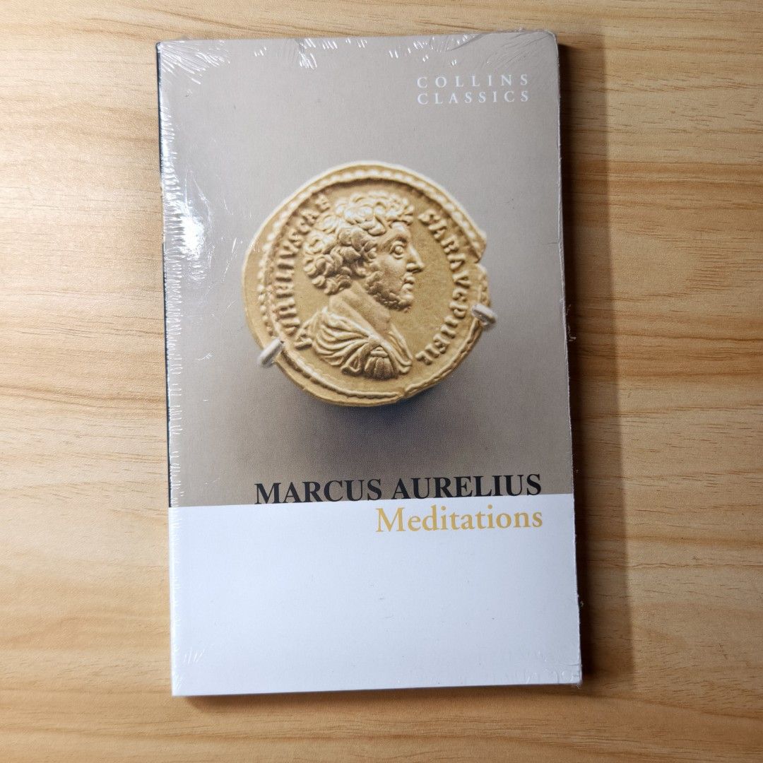 (AUTHENTIC) Collins Classics: Meditations by Marcus Aurelius (Category: Storybooks) located in Marikina City. Submitted by eriyaaah (Listing ID 1402471351, Image 1). Description: Copy of Marcus Aurelius' "Meditations" from the Collins Classics series. The book is sealed in its original plastic wrap. The cover features a gold-colored image of a Roman coin. The title and author's name are clearly printed on the front cover..