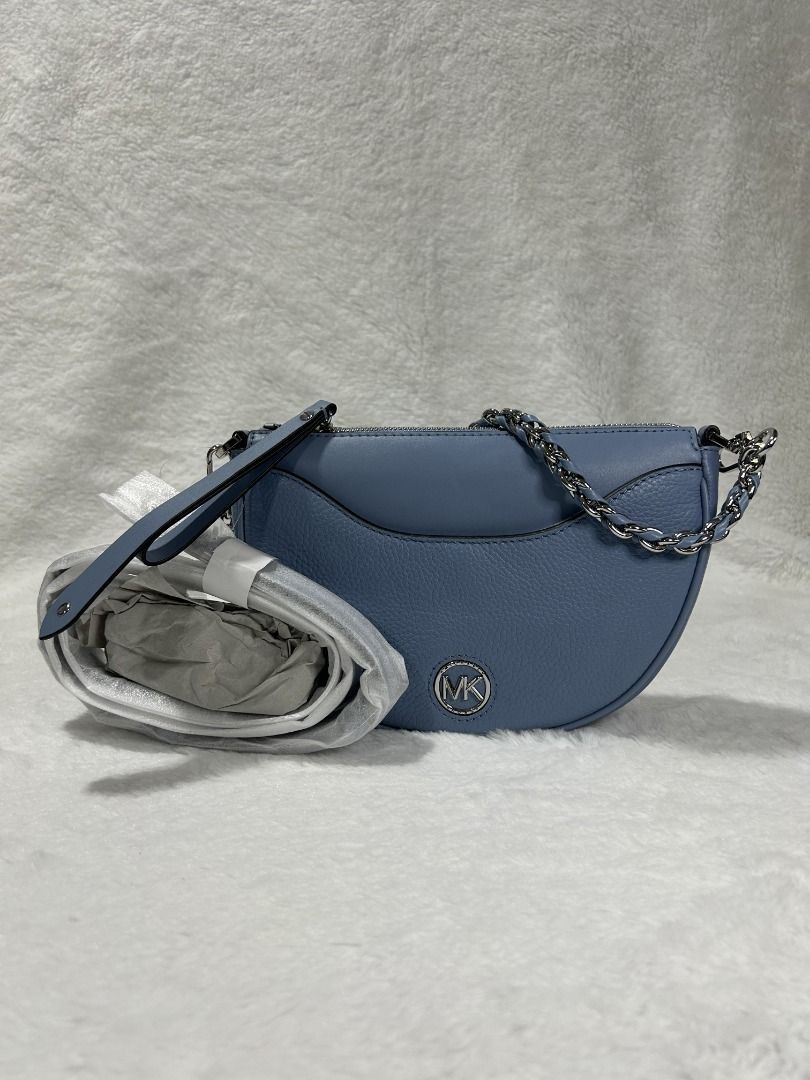 Authentic Michael Kors Dover Half Moon Leather Shoulder Bag (Category: Luxury Bags & Wallets) located in Manila. Submitted by jeanskiecloset (Listing ID 1402288054, Image 1). Description: 100% Authentic Michael Kors Dover Half Moon Leather Shoulder Bag PRODUCT DETAILS Top handle, 7.25" drop Removable, adjustable crossbody strap, 24" drop Dimensions: 9.75"W x 3"D x 6.25"H Zip closure Exterior slip pocket & snap pocket; interior zip pocket & slip p