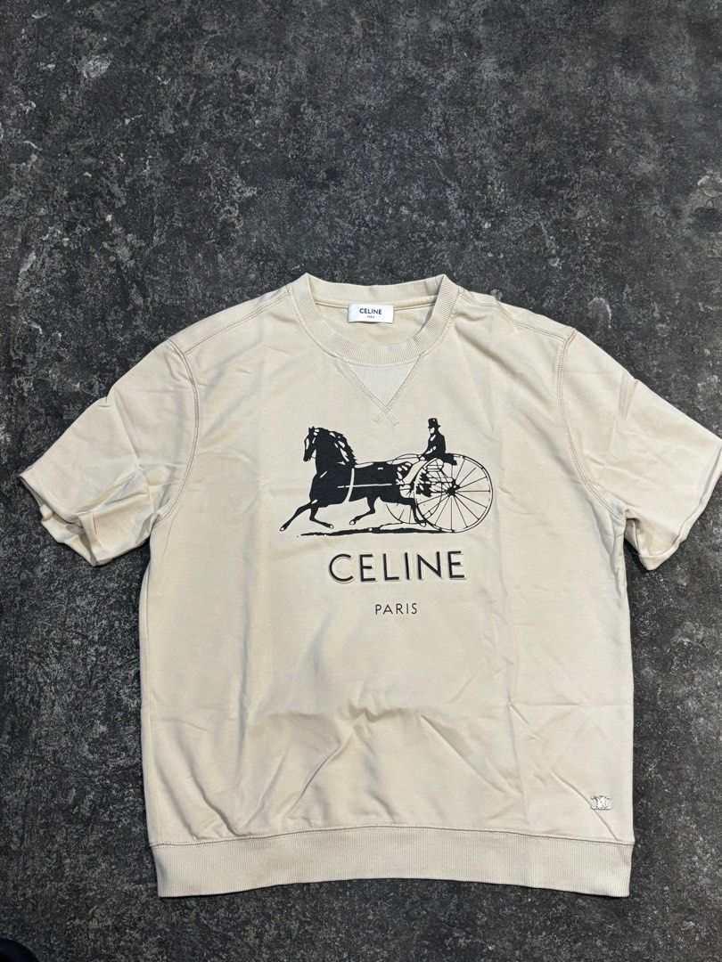Celine Paris Short Sleeve Sweatshirt (Category: Luxury Apparel) located in General Trias. Submitted by max_thrifted (Listing ID 1402340968, Image 1). Description: - Celine Paris sweatshirt -Small on tag -Weight: 21.2 -Length: 25 - Features iconic Celine logo and horse carriage graphic - Made from 100% cotton - Includes Celine label and size tag - Made in Italy -Like new .
