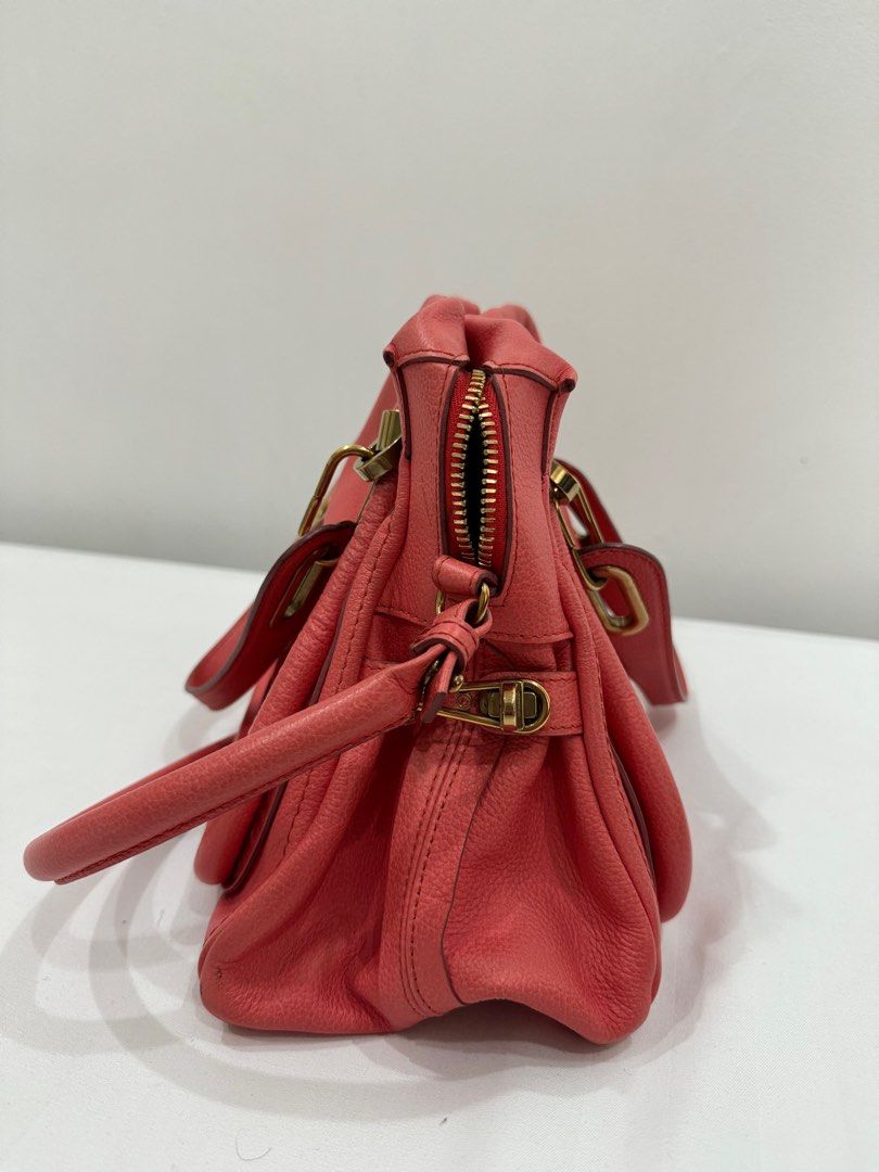 Chloe Paraty Handbag (Category: Luxury Bags & Wallets) located in Taguig. Submitted by getintomycloset (Listing ID 1402412164, Image 2). Description: - Chloe Paraty handbag - Coral color - Includes top handle and shoulder strap - Gold-toned hardware - Secure zipper closure - Textured leather finish - Classic, structured design.