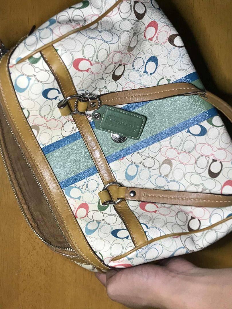 Coach Signature Handbag (Category: Luxury Bags & Wallets) located in Manila. Submitted by jaceiz (Listing ID 1402430273, Image 2). Description: - Coach signature handbag - Colorful pattern - Zip closure - Brown interior with pocket - Includes Coach tag - Brown leather trim and handles - Green and blue stripe design.