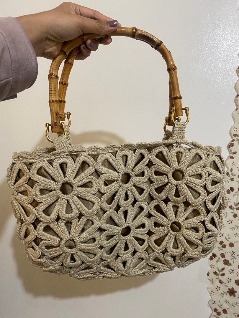 Crochet Floral Handbag with Bamboo Handle (Category: Tote Bags) located in Baguio. Submitted by leeala (Listing ID 1402334156, Image 1). Description: - Crochet floral design - Bamboo handles - Gold-colored hardware - Satin-lined interior - Drawstring closure - Neutral color.