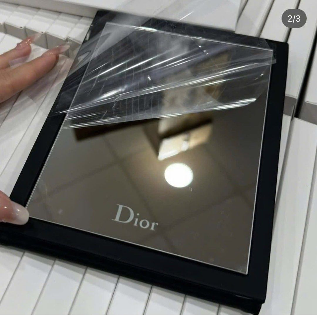 Dior Compact Mirror (Category: Mirrors) located in Imus. Submitted by diana2999 (Listing ID 1402462729, Image 2). Description: - Authentic Dior compact mirror - Features a black, leather-like exterior - Adorned with the iconic Dior logo - Mirror protected by a plastic film - Perfect for on-the-go touch-ups Eta: November 25 +200 for paperbag .
