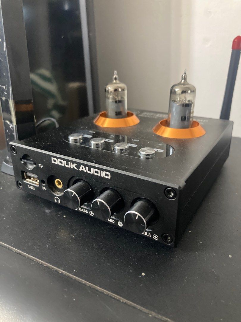 Douk Audio HiFi Tube P2 Preamp (Category: Soundbars, Speakers & Amplifiers) located in Paniqui. Submitted by swiftdragon.c69cc8 (Listing ID 1396395994, Image 1). Description: - Douk Audio HiFi Tube P2 Preamp - Remote Control Included - Multiple Inputs: RCA, Bluetooth, USB, TF - Headphone Jack - Tone Controls: Bass, Mid, Treble - Stylish Design: Black finish with gold accents - Includes two visible tubes.