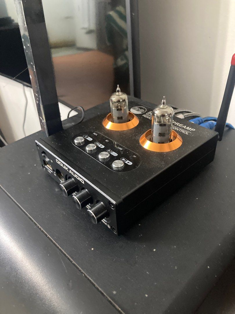 Douk Audio HiFi Tube P2 Preamp (Category: Soundbars, Speakers & Amplifiers) located in Paniqui. Submitted by swiftdragon.c69cc8 (Listing ID 1396395994, Image 2). Description: - Douk Audio HiFi Tube P2 Preamp - Remote Control Included - Multiple Inputs: RCA, Bluetooth, USB, TF - Headphone Jack - Tone Controls: Bass, Mid, Treble - Stylish Design: Black finish with gold accents - Includes two visible tubes.