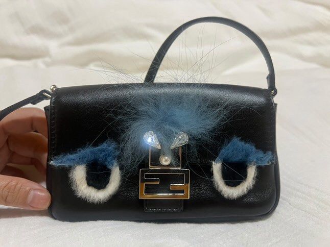 Fendi Micro Baguette “Monster” Bag (Category: Luxury Bags & Wallets) located in Marilao. Submitted by kjscloset_ (Listing ID 1402358060, Image 1). Description: - Authentic Fendi Micro Baguette bag - Black leather exterior - Chain strap and detachable shoulder strap - Unique design with fur accents and pearl detail - Includes dust bag, tags, and cards - Multiple interior compartments - Made in Italy.