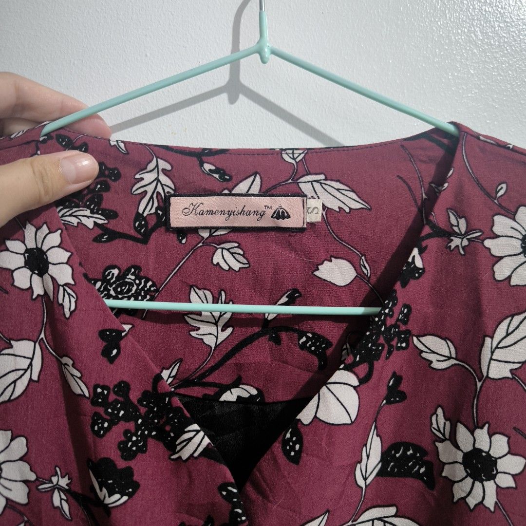 Maroon Floral Dress (Category: Dresses) located in Makati City. Submitted by mampuan (Listing ID 1402465435, Image 3). Description: - Floral print dress - Colors: Maroon, white, and black - Long sleeves - V-neck with button details - Elastic waist - Ruffled hem - Size: Small - With missing one button.