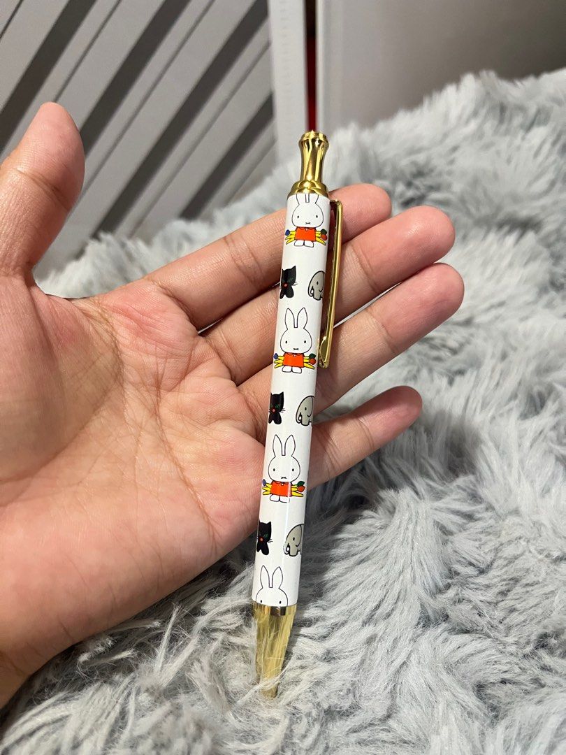 Miffy Ballpoint Pen (Category: Stationery & School Supplies) located in Bayombong. Submitted by ariannegay (Listing ID 1402477126, Image 1). Description: - Miffy ballpoint pen - White barrel with Miffy and character illustrations - Gold-colored tip and clip - Collectible item - Perfect for Miffy fans and stationery collectors.