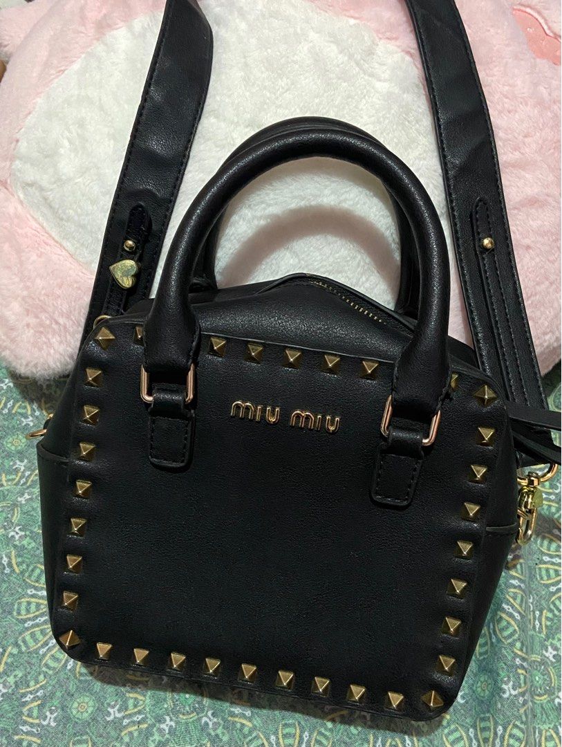 Miu Miu Black Studded Handbag With Sling (Category: Luxury Bags & Wallets) located in Talavera. Submitted by thr1ftyren (Listing ID 1402436620, Image 2). Description: Baka may looking po nito🚨 Miu Miu 2 way handle/sling leather bag Excellent condition Color rate 9.8/10 No issues Mine 1300 + sf Dm to purchase📥 📍Location Nueva Ecija.