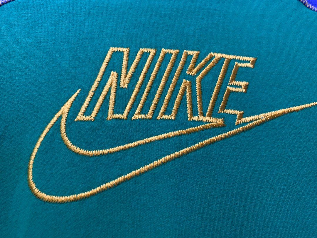 Nike Hoodie Green Blue Medium (Category: Hoodies) located in Angeles City. Submitted by danedane06 (Listing ID 1402388418, Image 3). Description: Nike hoodie in green and blue colorway. Features a front pocket and a Nike logo embroidered in yellow. The hoodie has a hood and long sleeves. Size is Medium. Made in Jordan..