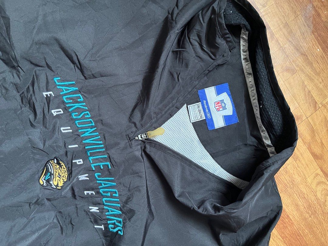 Reebok Jacksonville Jaguars Pullover Jacket (Category: Coats, Jackets and Outerwear) located in Quezon City. Submitted by chris.secondhand (Listing ID 1402365560, Image 3). Description: - Black Reebok pullover jacket - Jacksonville Jaguars logo on front - Half-zip closure - Side pockets - Lightweight polyester material - Mesh lining - NFL licensed product.