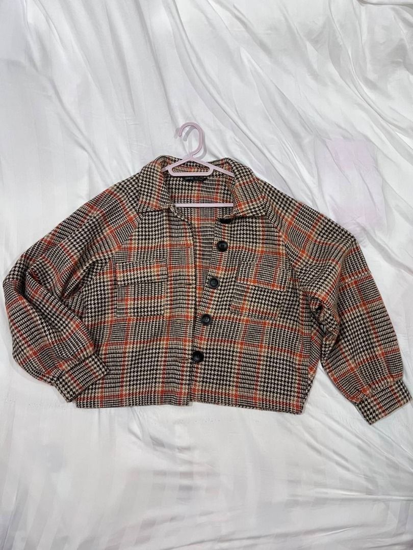 Shein Brown Plaid Cropped Jacket XS-M (Category: Coats, Jackets and Outerwear) located in Manila. Submitted by offthelabelmnl (Listing ID 1402373545, Image 2). Description: Shein Brown Plaid Cropped Jacket XS-M - Classic plaid pattern: brown, black, orange - Collared neckline - Button-down closure - Two front pockets - Long sleeves with buttoned cuffs Loc: Binondo, or BGC.