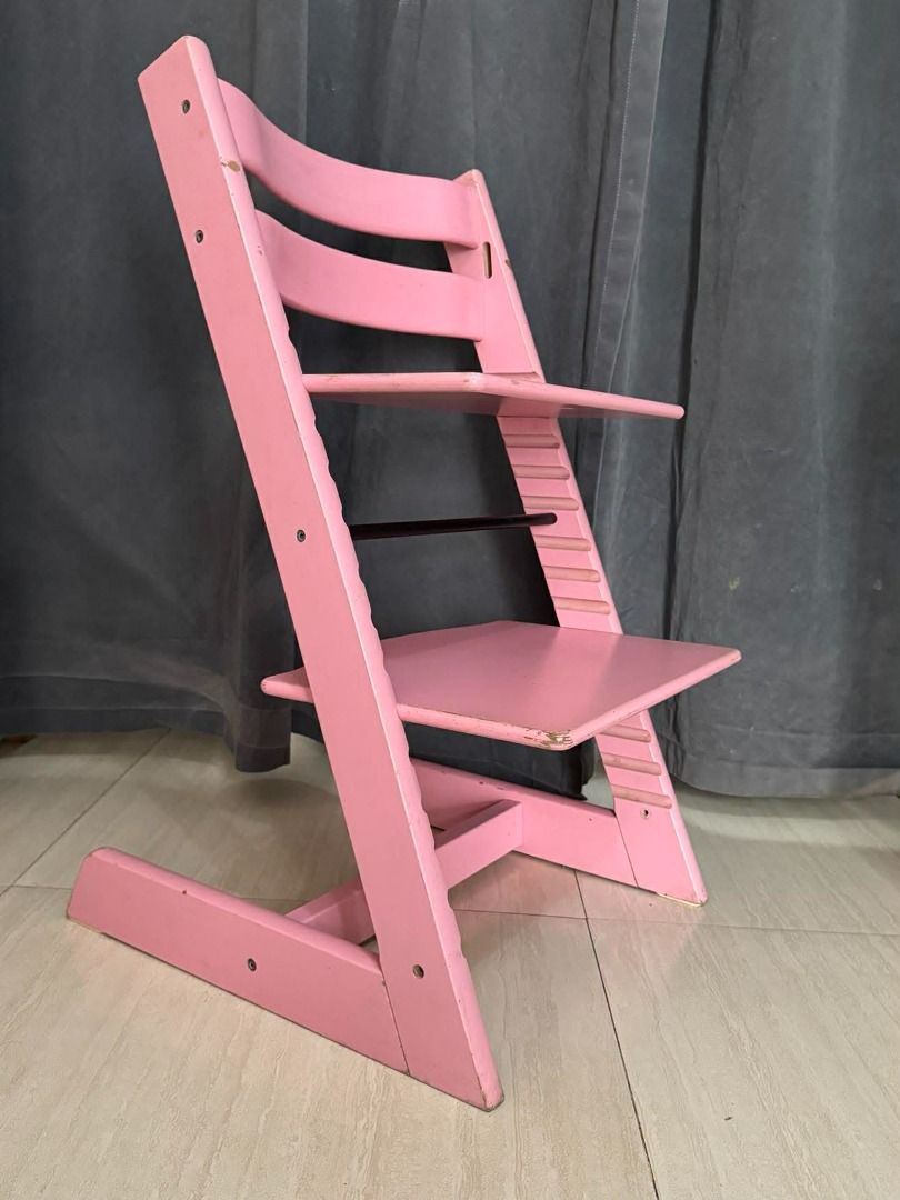 SALE!!! Stokke Tripp Trapp High Chair - Pink (Category: Kids Tables & Chairs) located in Quezon City. Submitted by GoYo_Ltd (Listing ID 1402316524, Image 3). Description: - Pink Stokke Tripp Trapp high chair - Wooden frame - Adjustable seat and footrest - Features a black support bar - Minor scratches and marks present - Stokke logo visible.