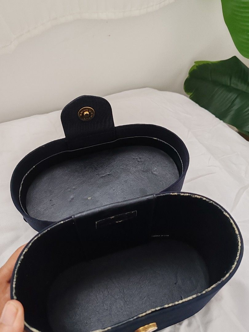 Vintage Dior Vanity Case (Category: Luxury Bags & Wallets) located in Lipa City. Submitted by wanderingmiss (Listing ID 1402418131, Image 3). Description: - Vintage navy blue vanity case - Features a top handle - Gold-toned oval emblem - Dark interior lining - Rectangular shape with rounded edges - Classic and elegant design Sold in other sites for 9,500.