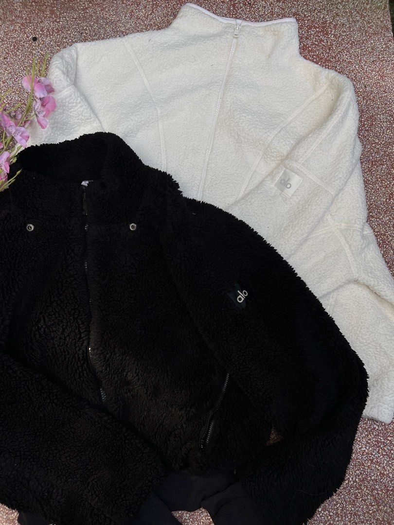Alo Sherpa Jacket (Category: Coats, Jackets and Outerwear) located in Taguig. Submitted by sbmanilaaa (Listing ID 1402525558, Image 1). Description: - Alo Sherpa Jacket - Available in Black and White - Features a zip-up front - High collar design - Alo logo detail on the sleeve - Made of soft, textured material - Ideal for casual wear and workouts.