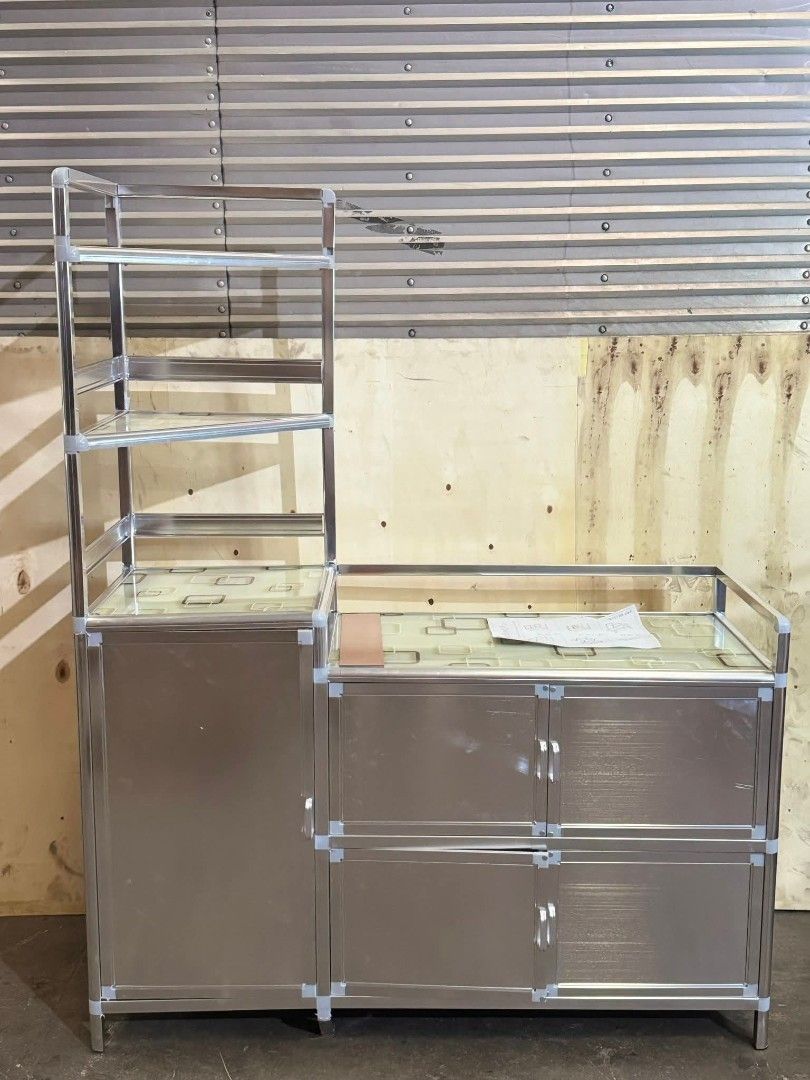 Aluminum Kitchen Cabinet with Shelves (Category: Shelves, Cabinets & Racks) located in Manila. Submitted by zdchloe (Listing ID 1402568273, Image 1). Description: - Aluminum kitchen cabinet - Features countertop surface - Includes multiple shelves and storage compartments - Offers doors and drawers for organized storage - Suitable for kitchen use - Provides both open and enclosed storage options.