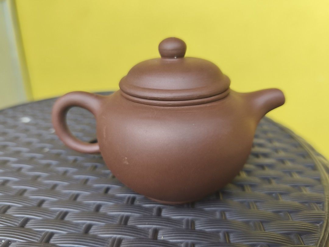 Authentic Yixing Teapot 60cc (Category: Coffee & Tea Tableware) located in Muntinlupa City. Submitted by prime_finder (Listing ID 1402523732, Image 2). Description: - Brown ceramic teapot - Includes matching lid - Features a handle and spout - Small, round design - Perfect for brewing tea - Solid brown color - Stamped bottom.