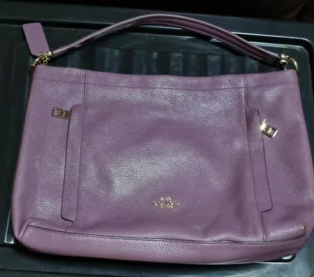 Coach Purple Shoulder Bag (Category: Luxury Bags & Wallets) located in Subic. Submitted by winlar (Listing ID 1402572798, Image 2). Description: - Purple Coach shoulder bag - Top handle and detachable shoulder strap - Exterior pockets with zipper closures - Coach logo on the front - Price: ₱1500.