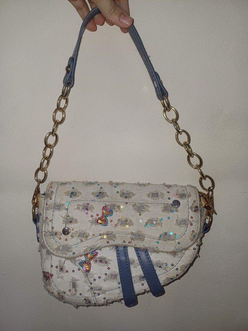 Sparkly Handbag (Category: Luxury Bags & Wallets) located in Quezon City. Submitted by declutterhouse (Listing ID 1402514509, Image 2). Description: - Unique design with embellished exterior - Chain strap - Blue accents - Adorned with sequins and butterfly details - Curved shape - Flap closure - Made of textured fabric.
