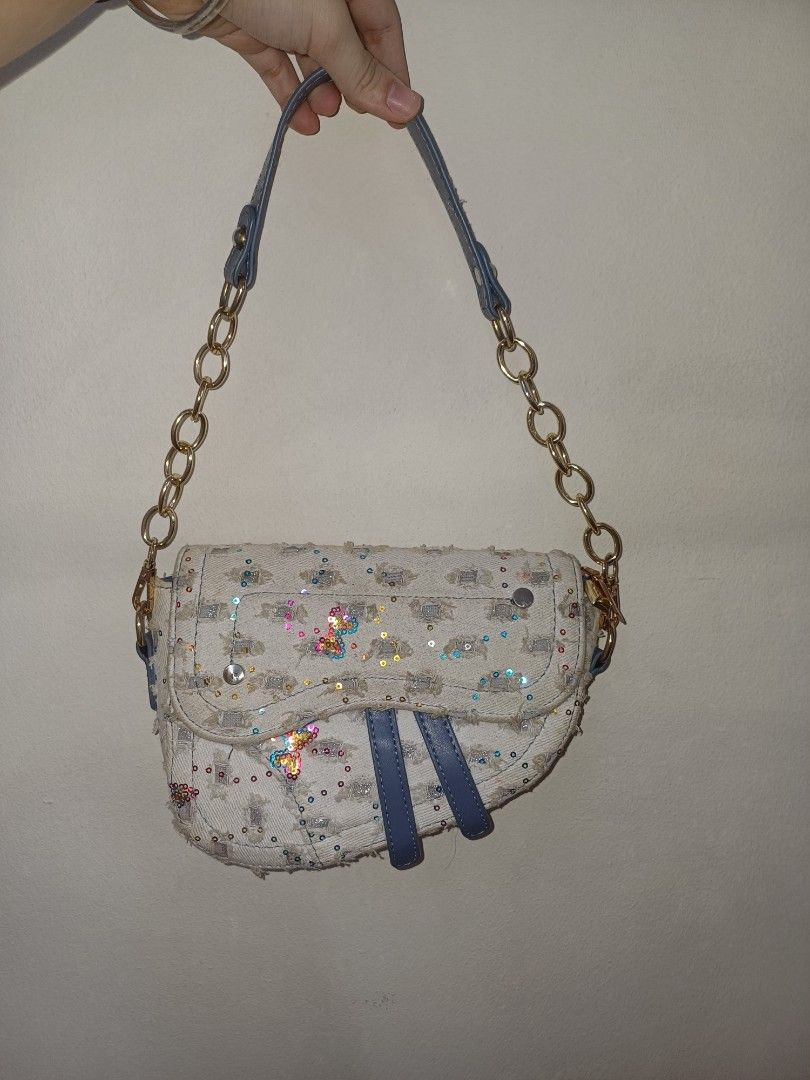Sparkly Handbag (Category: Luxury Bags & Wallets) located in Quezon City. Submitted by declutterhouse (Listing ID 1402514509, Image 1). Description: - Unique design with embellished exterior - Chain strap - Blue accents - Adorned with sequins and butterfly details - Curved shape - Flap closure - Made of textured fabric.