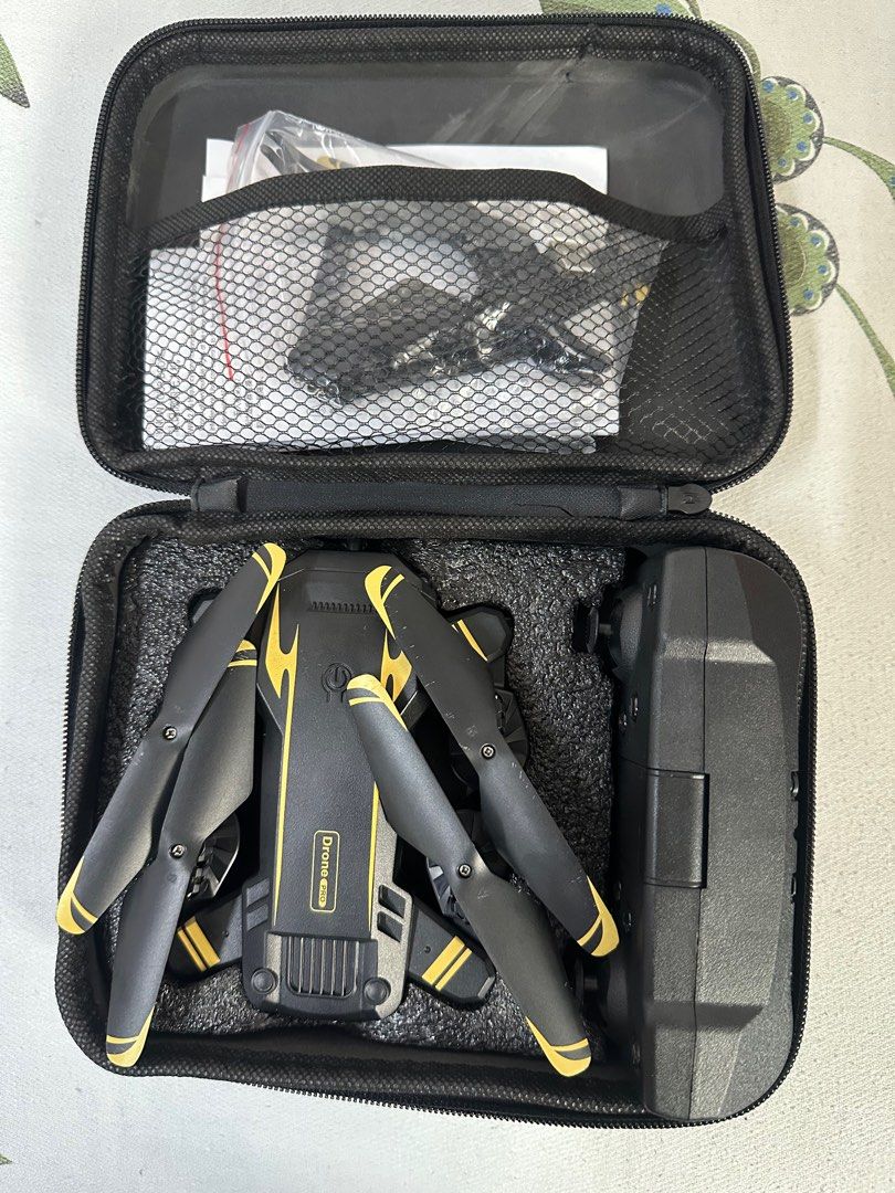 Foldable Drone with Remote Control (Category: Drones) located in Quezon City. Submitted by jepsil0g (Listing ID 1402661958, Image 2). Description: - Foldable drone (actual color may vary) - Includes remote control and carrying case - Foldable arms for compact storage - Remote control with multiple buttons and joysticks.