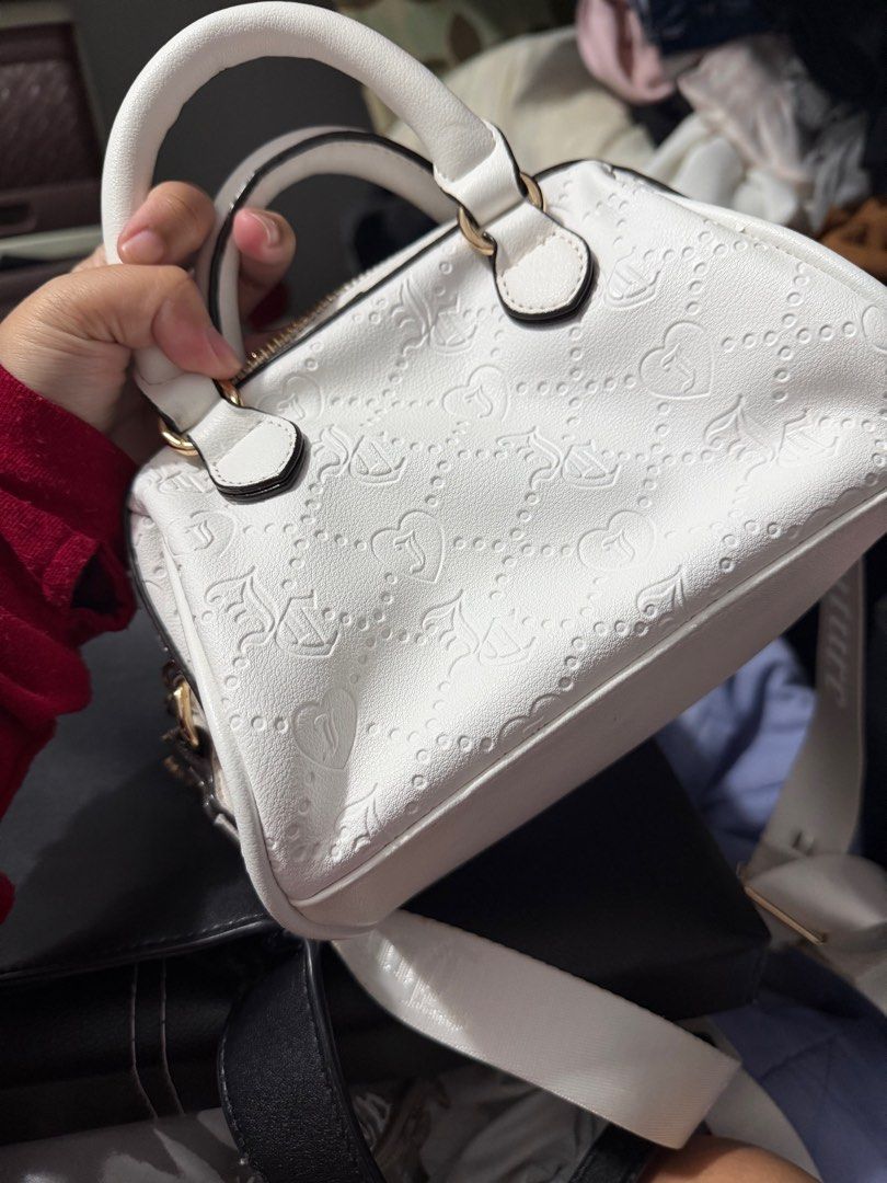Juicy Couture White Handbag (Category: Luxury Bags & Wallets) located in Taguig. Submitted by megdeclutter (Listing ID 1402641869, Image 3). Description: Juicy Couture white handbag. Top handle, detachable strap, zipper closure. Features Juicy Couture logo and charm. ORIGINAL, NO FLAWS .