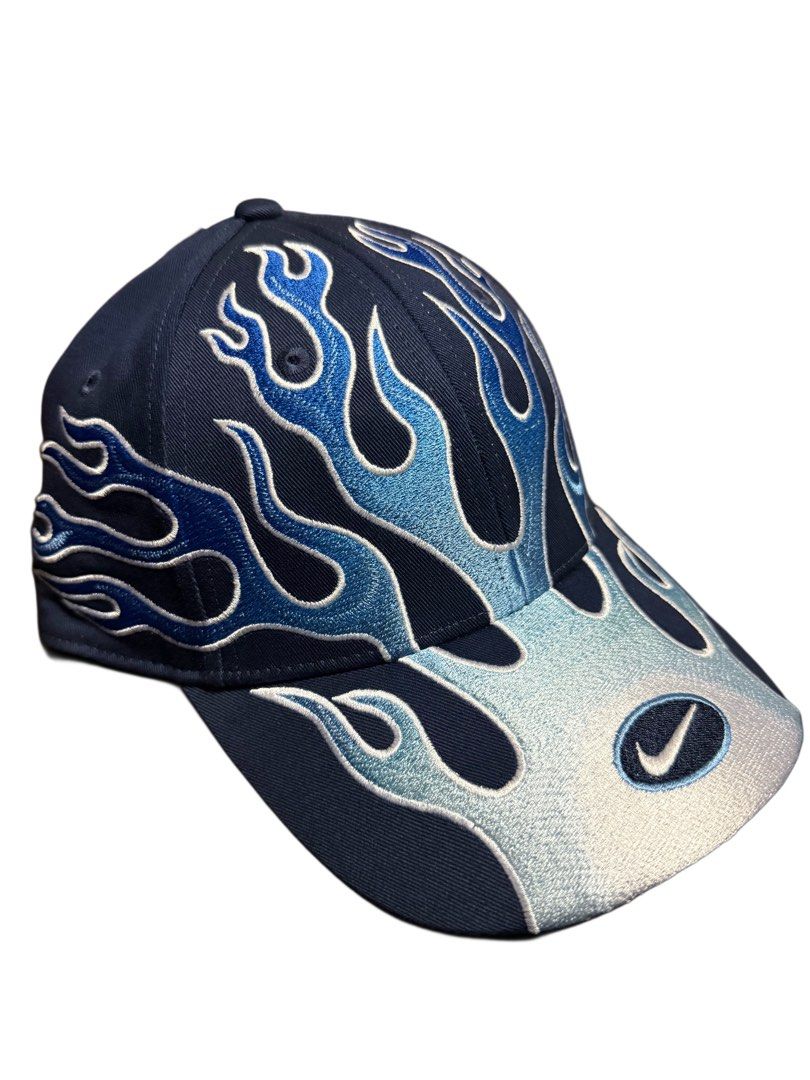 Nike Club Cap Flame Design S/M (Category: Caps & Hats) located in Manila. Submitted by blvckyeezus (Listing ID 1402573063, Image 1). Description: FOR SALE!! Bnew Nike Club Cap FLAME CAP Retro features a unique flame design. It is a navy blue cap with blue and light blue flame embroidery. Size: S/M and made of cotton and polyester. It has the Nike logo embroidered on the front and the inside. The tag indicates it is an adult unisex cap. ₱1,995 + S