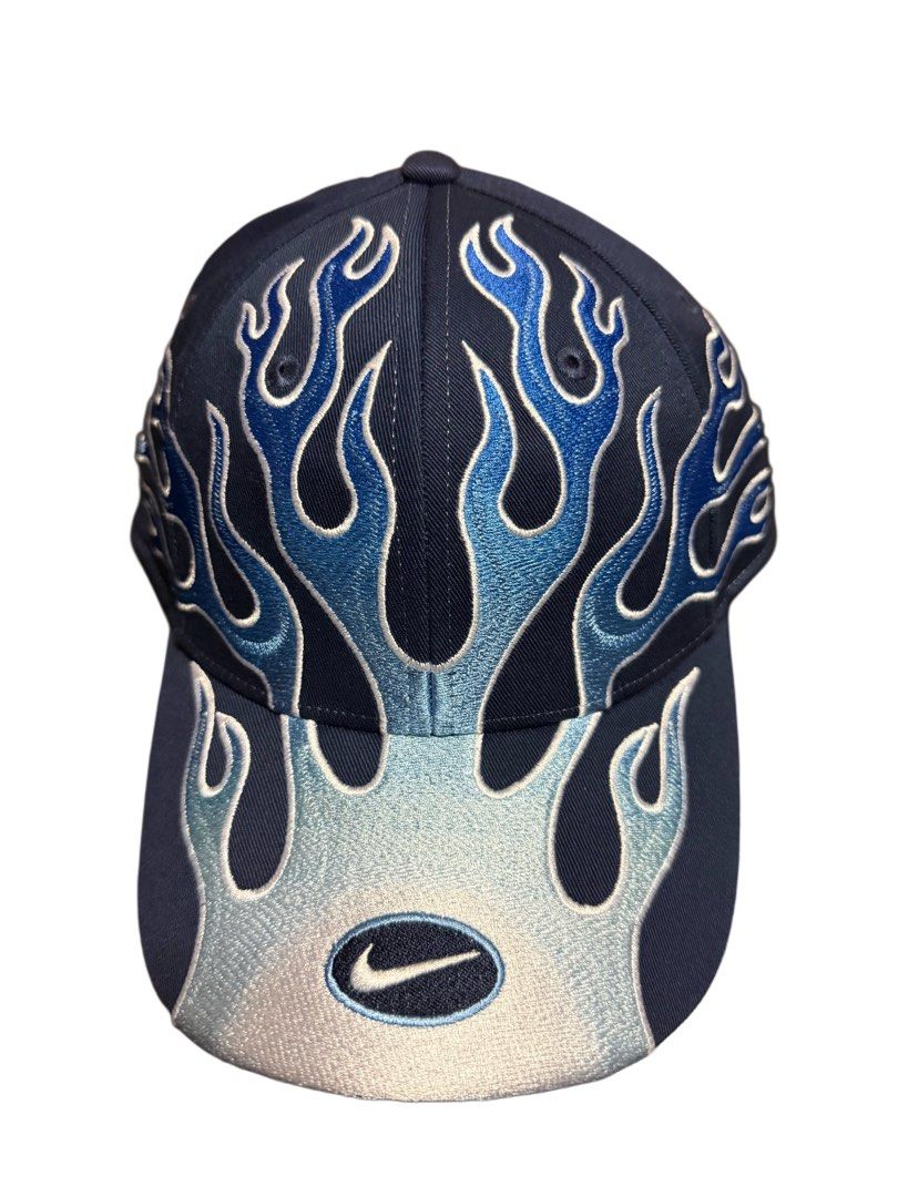 Nike Club Cap Flame Design S/M (Category: Caps & Hats) located in Manila. Submitted by blvckyeezus (Listing ID 1402573063, Image 2). Description: FOR SALE!! Bnew Nike Club Cap FLAME CAP Retro features a unique flame design. It is a navy blue cap with blue and light blue flame embroidery. Size: S/M and made of cotton and polyester. It has the Nike logo embroidered on the front and the inside. The tag indicates it is an adult unisex cap. ₱1,995 + S