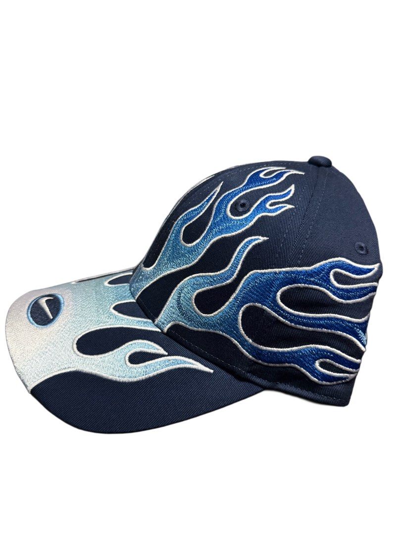 Nike Club Cap Flame Design S/M (Category: Caps & Hats) located in Manila. Submitted by blvckyeezus (Listing ID 1402573063, Image 3). Description: FOR SALE!! Bnew Nike Club Cap FLAME CAP Retro features a unique flame design. It is a navy blue cap with blue and light blue flame embroidery. Size: S/M and made of cotton and polyester. It has the Nike logo embroidered on the front and the inside. The tag indicates it is an adult unisex cap. ₱1,995 + S