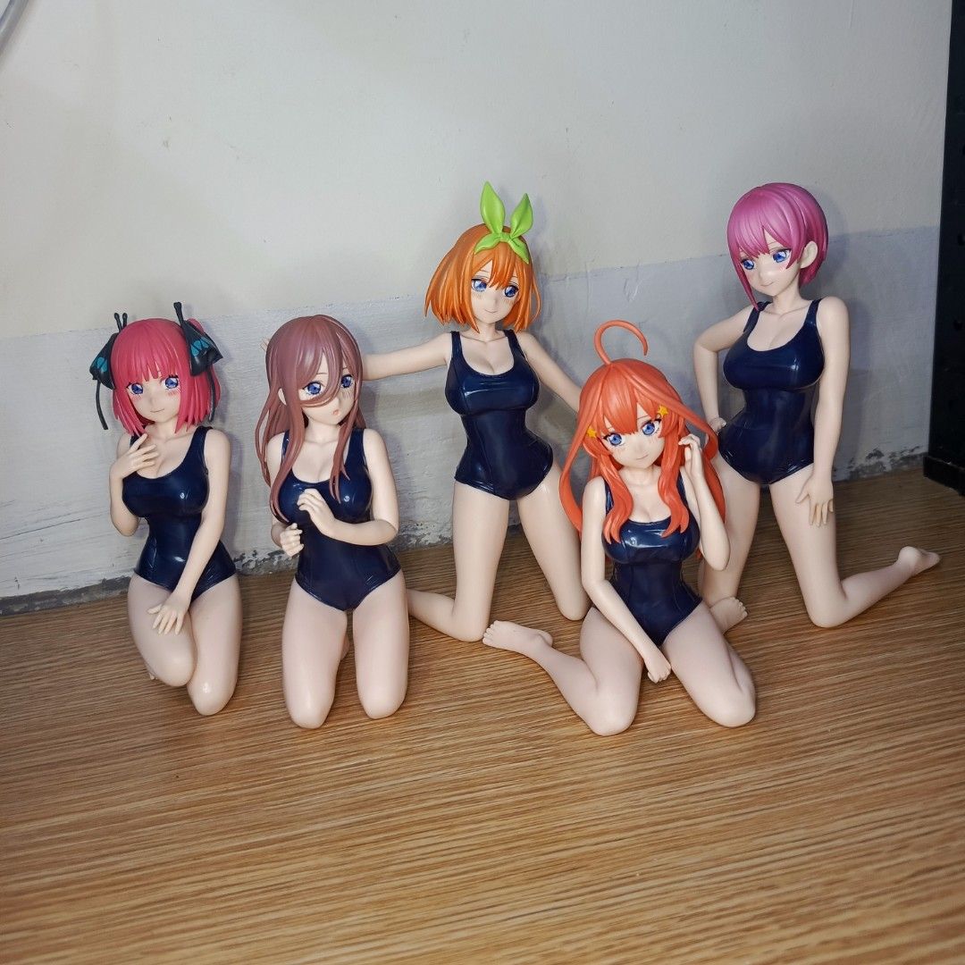 The Quintessential Quintuplets Swimsuit Figures (Category: Figurines & Statues) located in Binan City. Submitted by joamy0816616 (Listing ID 1402516076, Image 1). Description: Set of five The Quintessential Quintuplets figures in swimwear. Each figure features a different quintuplet. They are in a kneeling pose. The figures have detailed facial features and hair. The swimsuits are dark blue. These figures are perfect for any fan of the series..