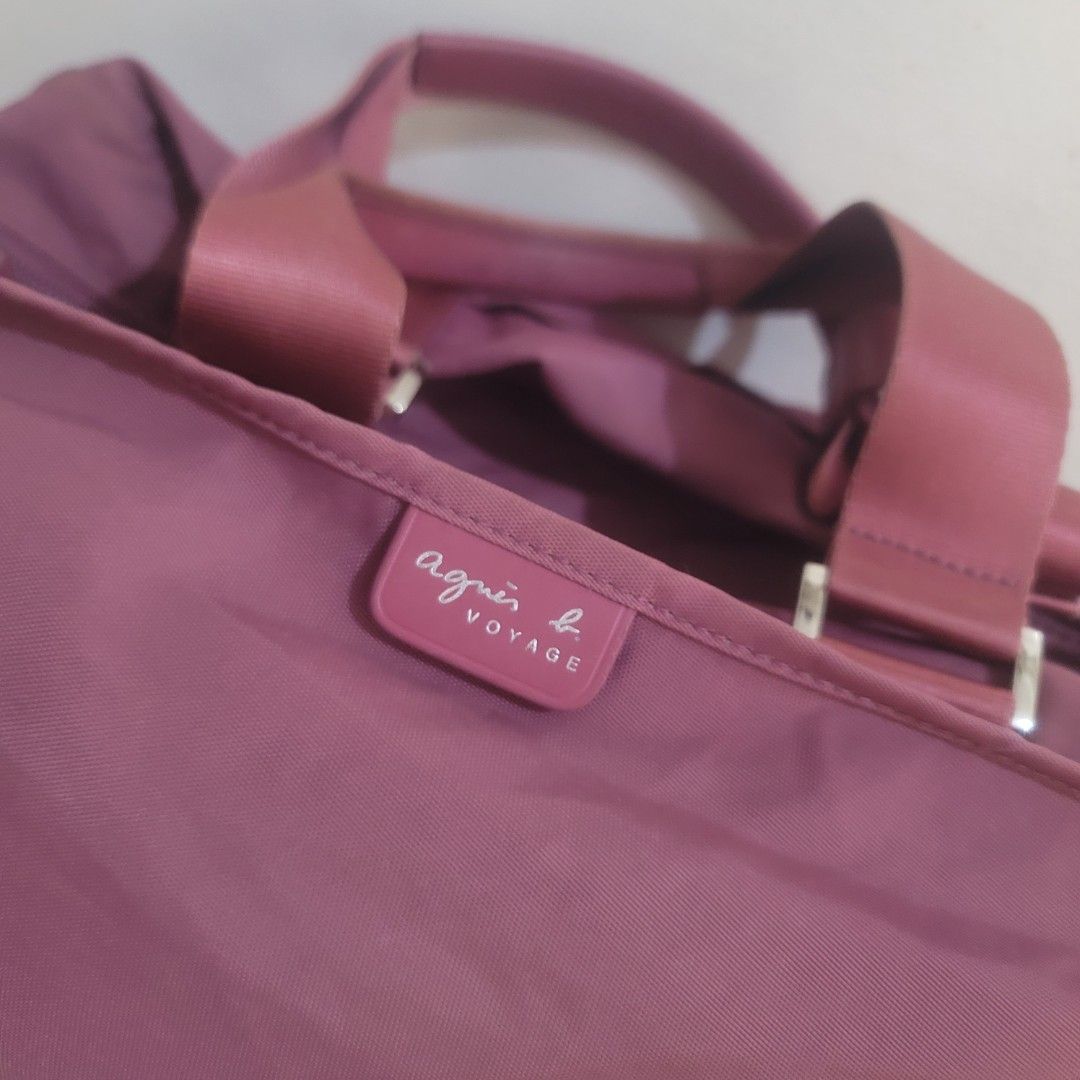 Agnes B. Voyage Shoulder Weekender Bag (Category: Luxury Bags & Wallets) located in Pasig City. Submitted by bunny.bella (Listing ID 1402703332, Image 2). Description: - Agnes B. Voyage shoulder bag - Lovely mauve color - Top handle and detachable shoulder strap - Zipper closure - Spacious interior with a small pocket - Silver hardware - Minor tear on the side Retails more than 10k up Still almost new but a little tear kn the side.