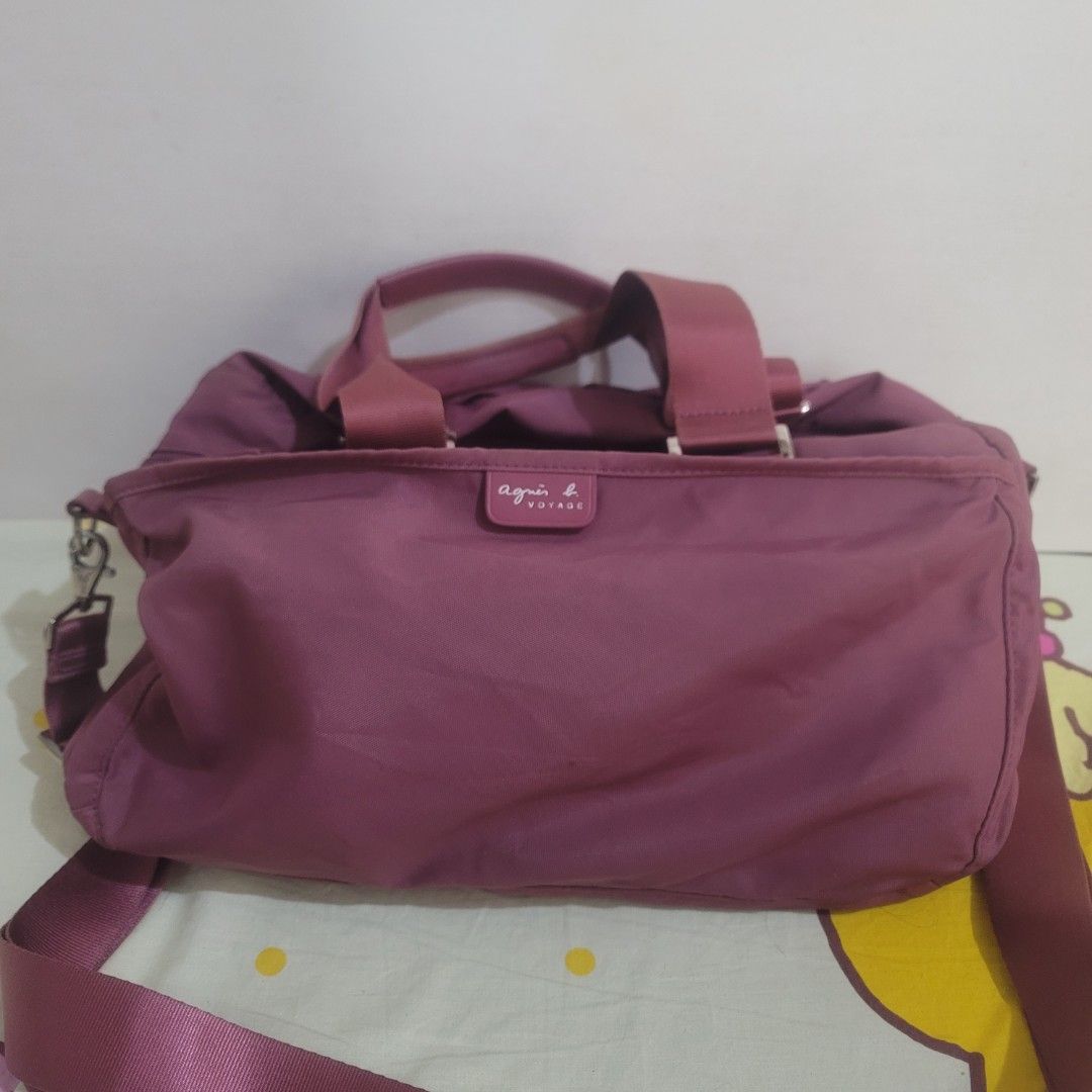 Agnes B. Voyage Shoulder Weekender Bag (Category: Luxury Bags & Wallets) located in Pasig City. Submitted by bunny.bella (Listing ID 1402703332, Image 1). Description: - Agnes B. Voyage shoulder bag - Lovely mauve color - Top handle and detachable shoulder strap - Zipper closure - Spacious interior with a small pocket - Silver hardware - Minor tear on the side Retails more than 10k up Still almost new but a little tear kn the side.