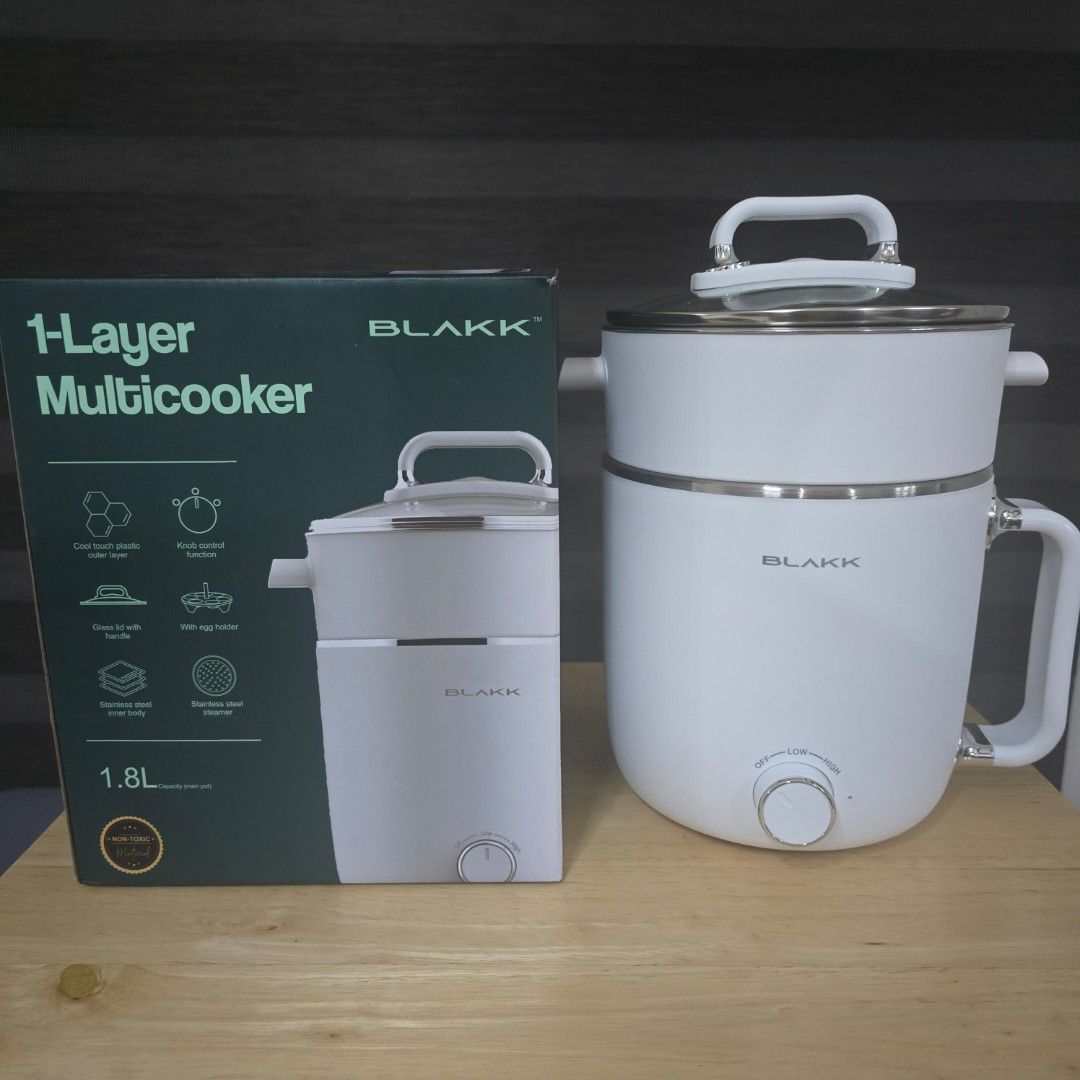 Blakk 1-Layer Multicooker 1.8L (Category: Cookware & Accessories) located in Bacoor. Submitted by haru.tidyup (Listing ID 1402799967, Image 1). Description: Blakk 1-Layer Multicooker has a 1.8L capacity. It features a stainless steel inner body, cool-touch plastic outer layer, and a glass lid with a handle. It also includes a stainless steel steamer and an egg holder. The multicooker has a knob control function. ---- 💵 Payment Method: GCash/BPI/