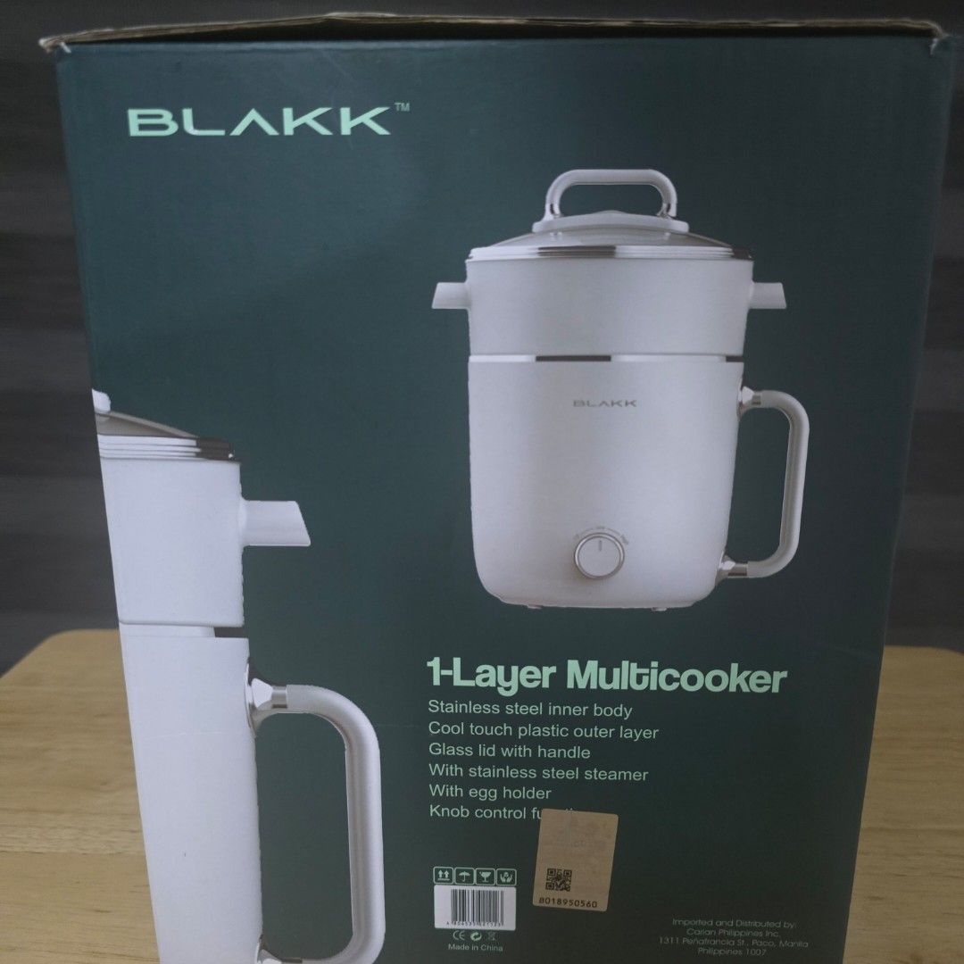 Blakk 1-Layer Multicooker 1.8L (Category: Cookware & Accessories) located in Bacoor. Submitted by haru.tidyup (Listing ID 1402799967, Image 3). Description: Blakk 1-Layer Multicooker has a 1.8L capacity. It features a stainless steel inner body, cool-touch plastic outer layer, and a glass lid with a handle. It also includes a stainless steel steamer and an egg holder. The multicooker has a knob control function. ---- 💵 Payment Method: GCash/BPI/
