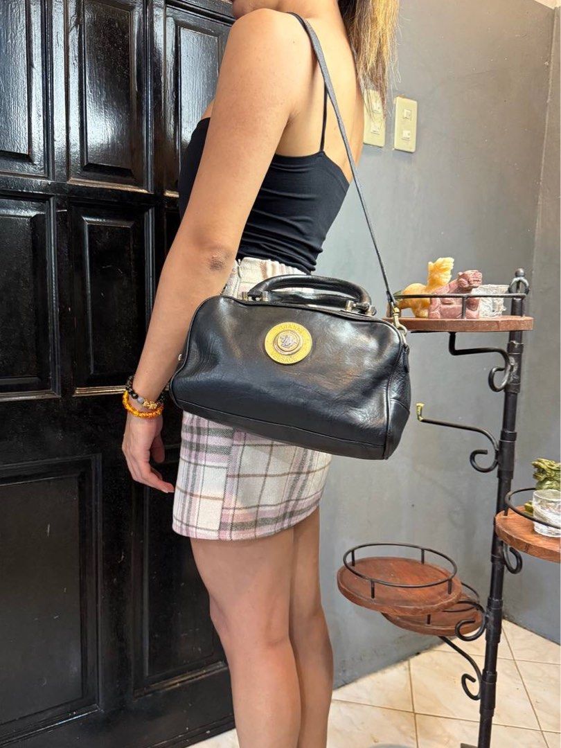 Gianni Versace Two-way Leather Bag (Category: Luxury Bags & Wallets) located in Baguio. Submitted by BagstacularbyJCT (Listing ID 1402790187, Image 3). Description: This Versace bag features a black leather body with gold-toned hardware. The bag opens through a zip-top closure revealing a spacious interior lined with fabric. This bag also comes with a detachable leather strap. Approx. dimension: 11x6x5 in Please take note❗️: This item is a pre-ow
