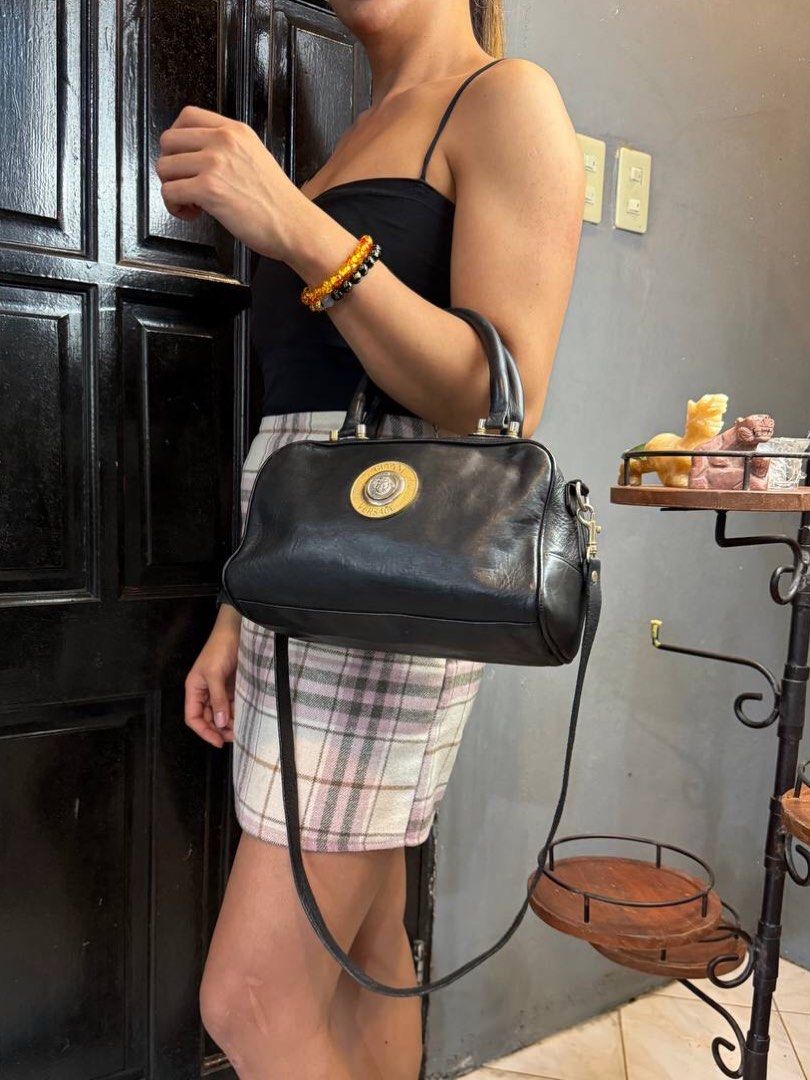 Gianni Versace Two-way Leather Bag (Category: Luxury Bags & Wallets) located in Baguio. Submitted by BagstacularbyJCT (Listing ID 1402790187, Image 2). Description: This Versace bag features a black leather body with gold-toned hardware. The bag opens through a zip-top closure revealing a spacious interior lined with fabric. This bag also comes with a detachable leather strap. Approx. dimension: 11x6x5 in Please take note❗️: This item is a pre-ow