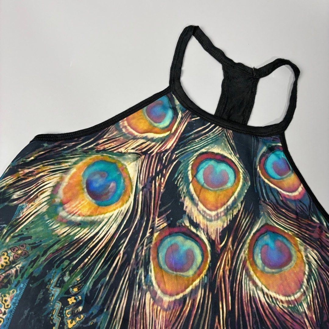 Hollister Peacock Print Tank Top - Size S (Category: Sleeveless) located in Angeles City. Submitted by tey68 (Listing ID 1402802424, Image 2). Description: - Hollister tank top - Size: Small - Design: Peacock feather print - Style: Halter neck - Features a black strap - Decorative trim at the bottom - Unique and stylish design.