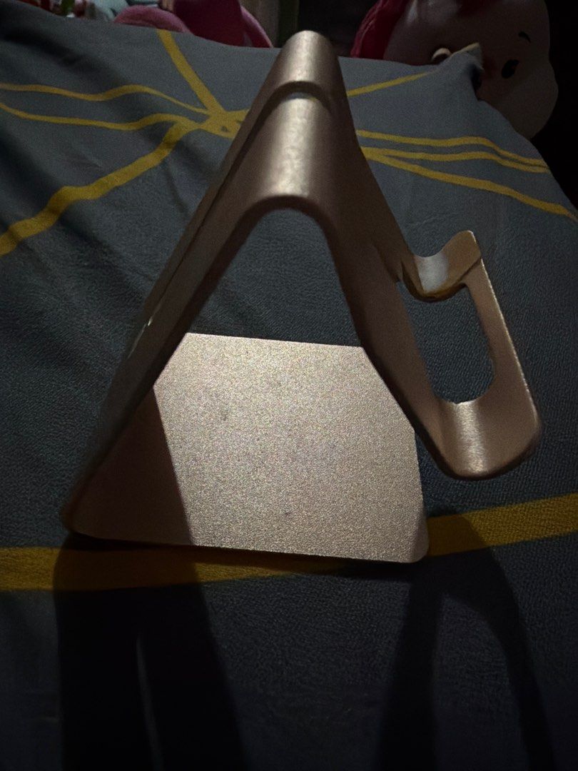 Metal Phone Stand (Category: Mounts & Holders) located in Pasig City. Submitted by etcyshop (Listing ID 1402806404, Image 2). Description: - Metal phone stand - Securely holds your phone - Sleek, minimalist design - Sturdy base for stability - Color: Rose Gold - Ideal for watching videos, video calls, or keeping your phone in view.
