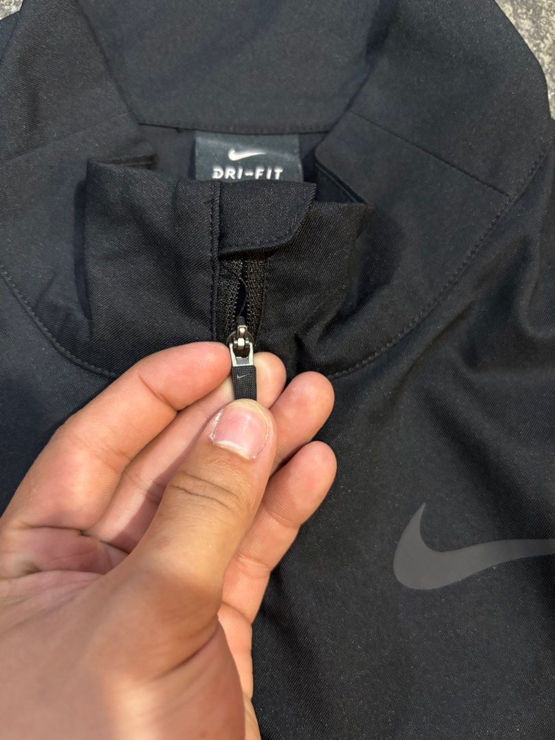 Nike Dri-FIT Standard Fit Jacket - Black (Category: Coats, Jackets and Outerwear) located in General Trias. Submitted by max_thrifted (Listing ID 1402808827, Image 2). Description: - Medium on tag - Weight: 20 - Length: 26 - Exellent condition - No issue - Like new Black Nike Dri-FIT jacket. Features a full-length zipper and the Nike logo on the chest. The jacket is a standard fit and made in Vietnam. The size is M. The jacket has a high collar..