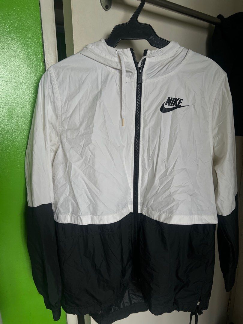 Nike Windbreaker and Topman Jacket (Category: Coats, Jackets and Outerwear) located in Manila. Submitted by max0693 (Listing ID 1402703160, Image 3). Description: Nike windbreaker jacket features a white and black color block design with a hood and a full zip closure. The Nike logo is visible on the chest. It has a drawstring at the hem for an adjustable fit. The Topman is worn on a smart casual kind of look. This is a thick jacket with a very ni