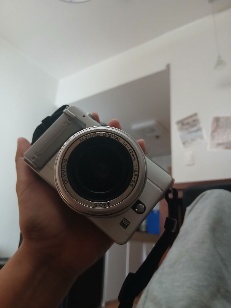 Olympus m.zuiko Digital Camera (Category: Cameras) located in Caloocan City. Submitted by rustiakarl62146 (Listing ID 1402727310, Image 2). Description: - Olympus M.Zuiko Digital camera - 14-42mm lens included - White camera body - Screen message: Check lens status - Includes camera strap - Features buttons and dial on top.