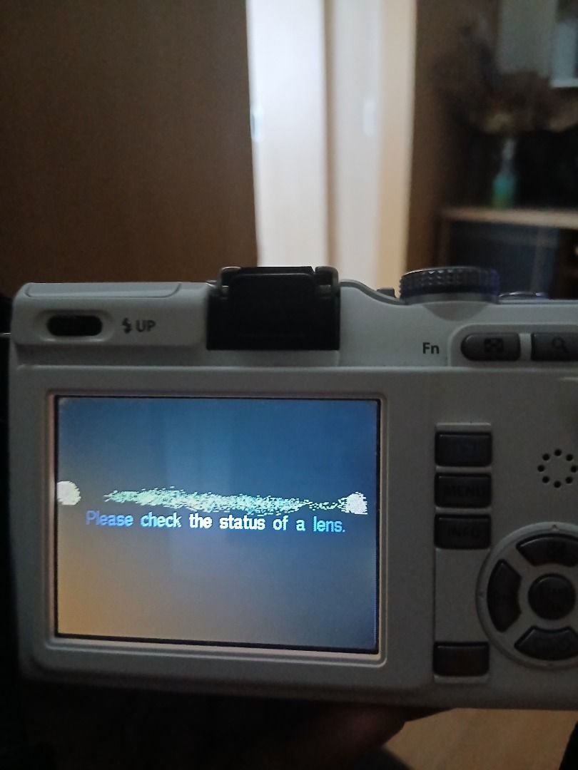 Olympus m.zuiko Digital Camera (Category: Cameras) located in Caloocan City. Submitted by rustiakarl62146 (Listing ID 1402727310, Image 3). Description: - Olympus M.Zuiko Digital camera - 14-42mm lens included - White camera body - Screen message: Check lens status - Includes camera strap - Features buttons and dial on top.