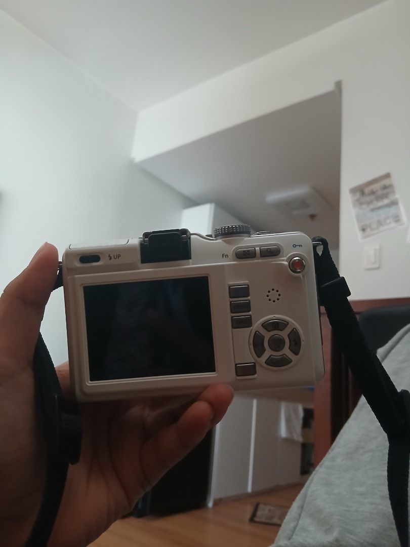Olympus m.zuiko Digital Camera (Category: Cameras) located in Caloocan City. Submitted by rustiakarl62146 (Listing ID 1402727310, Image 1). Description: - Olympus M.Zuiko Digital camera - 14-42mm lens included - White camera body - Screen message: Check lens status - Includes camera strap - Features buttons and dial on top.