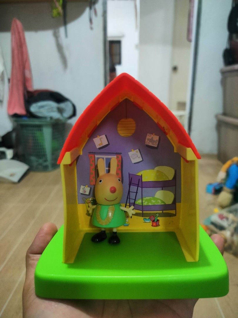 Peppa Pig Rabbit House Toy (Category: Kids Toys) located in Plaridel. Submitted by klayskolektibols (Listing ID 1402803157, Image 1). Description: - Peppa Pig Rabbit House Toy - Features a colorful house with red roof, yellow walls, and green base. - Includes a rabbit figure wearing a green dress. - House has bunk beds and wall decorations. - Perfect for kids!.