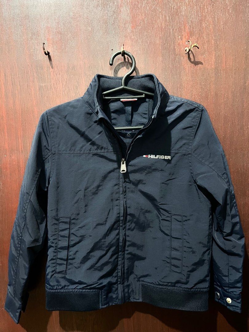 Tommy Hilfiger Navy Jacket (Category: Babies & Kids Fashion) located in Manila. Submitted by _baglover21 (Listing ID 1402828763, Image 1). Description: - Tommy Hilfiger navy jacket used twice - Size: S/P (6-7) - Full zip closure - With packable hoody -10/10 condition.
