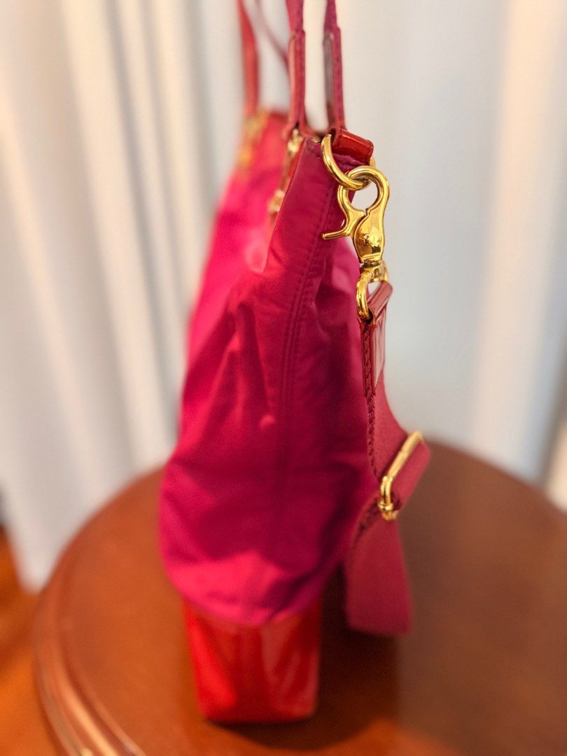 Tory Burch Pink Tote Bag (Category: Luxury Bags & Wallets) located in San Fernando. Submitted by mandts_closet (Listing ID 1402713014, Image 3). Description: - Tory Burch tote bag - Vibrant pink nylon body - Red patent leather accents - Top handle and detachable shoulder strap - Gold-tone hardware - Signature Tory Burch logo - Patterned interior lining - Zippered pocket Sold as is. No refunds. RFS: decluttering For shipping only..
