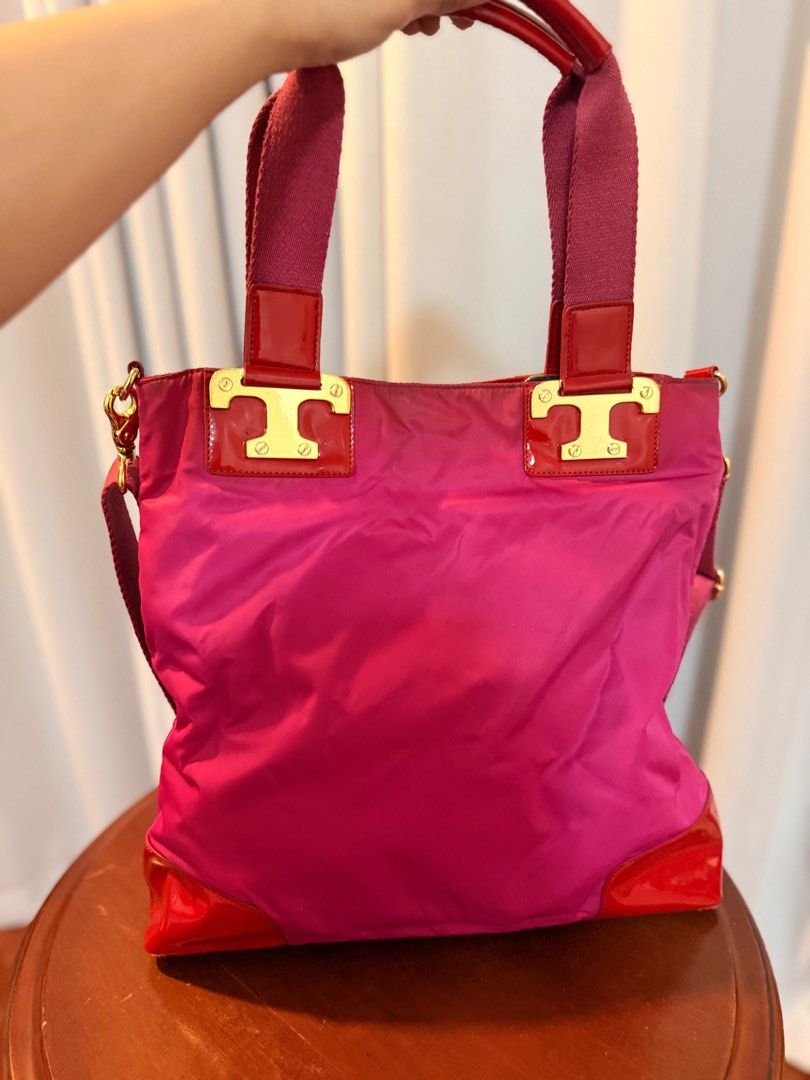 Tory Burch Pink Tote Bag (Category: Luxury Bags & Wallets) located in San Fernando. Submitted by mandts_closet (Listing ID 1402713014, Image 1). Description: - Tory Burch tote bag - Vibrant pink nylon body - Red patent leather accents - Top handle and detachable shoulder strap - Gold-tone hardware - Signature Tory Burch logo - Patterned interior lining - Zippered pocket Sold as is. No refunds. RFS: decluttering For shipping only..