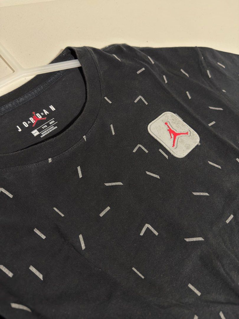 Air Jordan (Reflective Jumpman Logo) (Category: Tshirts & Polo Shirts ) located in Bulacan. Submitted by streethrifter (Listing ID 1402850458, Image 3). Description: Jordan Legacy AJ5 AOP Short Sleeve T-Shirt (Black, Reflective Print) 📏 Size: Width — 22 inches Length — 27 inches 🧸 Condition: 8/10 — Patina black looks even and clean. No scratches, pinholes, or stains. Minor issue: small spots on the reflective logo (see photo for detail). 🎨 Col